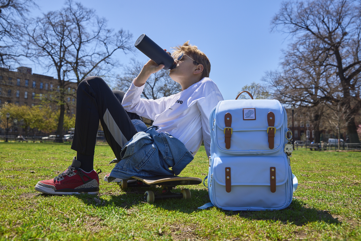 Child packing their own school backpack with checklist